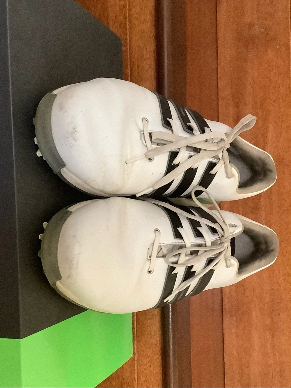 adidas White Golf Shoes with Black Stripes and Green Heel Accent